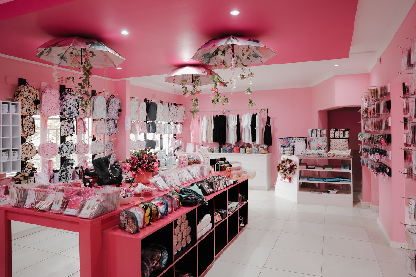 Inside the Wild Mongoo pink shop in George, tables and shelves full of handmade women-made products